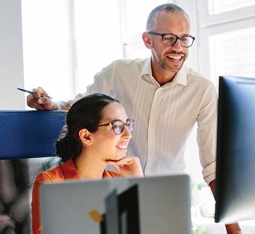 woman and man working at a computer